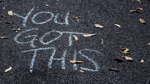 A photo of the sentence "you got this" written on the street with chalk. Illustrates [alt text].