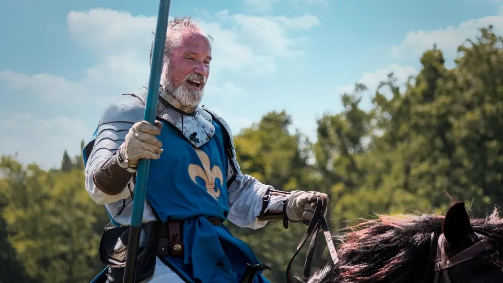 A photo of an elderly man LARPing as a knight.