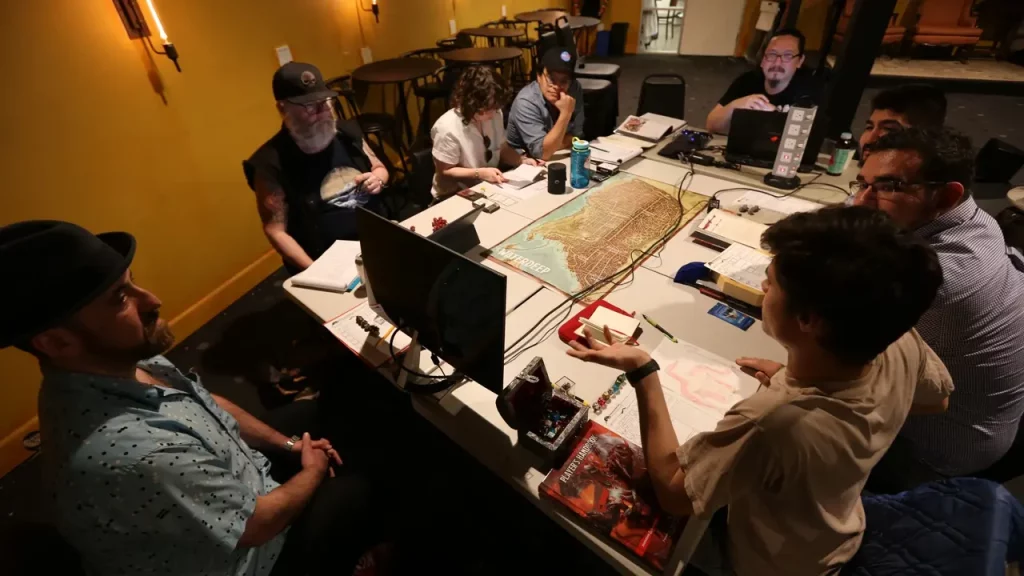 A photo of people playing TTRPG using technology.