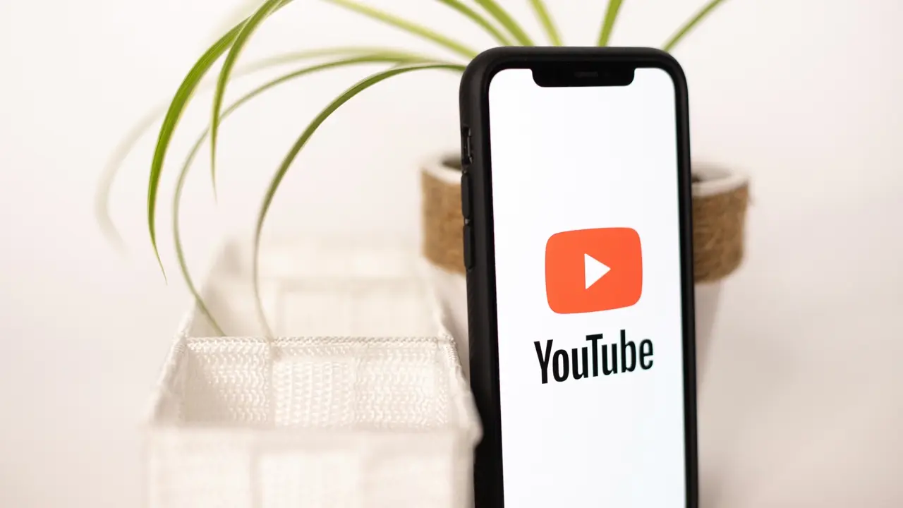 A photo of a smartphone with a YouTube logo. Illustrates YouTube TTRPG.