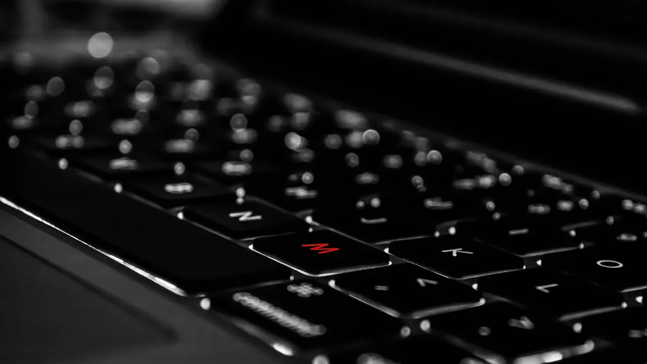 An edited photo of a laptop keyboard with the letter M highlighted. Illustrates YouTube TTRPG.