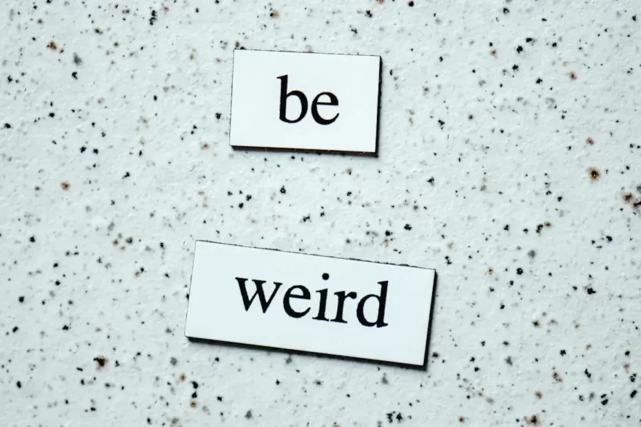 A photo of two pieces of cardboard written "be" and "weird."-