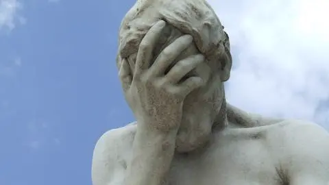 A photo of the Paris Tuileries Garden Facepalm statue. Illustrates [alt text].