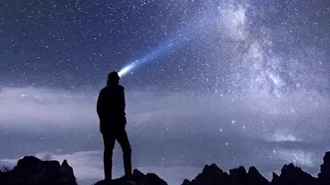 A photo of a man's silhouette staring at a beautiful, starry sky. Illustrates [alt text].