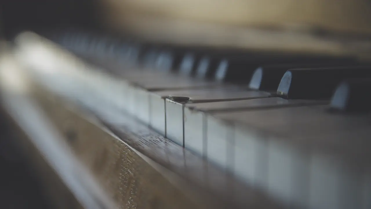 A close up photo of an antique piano. Illustrates [alt text].