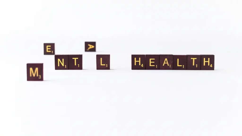a-set-of-wooden-blocks-spelling-the-word-mental A set of wooden blocks spelling the word mental health words in scrabble letters.