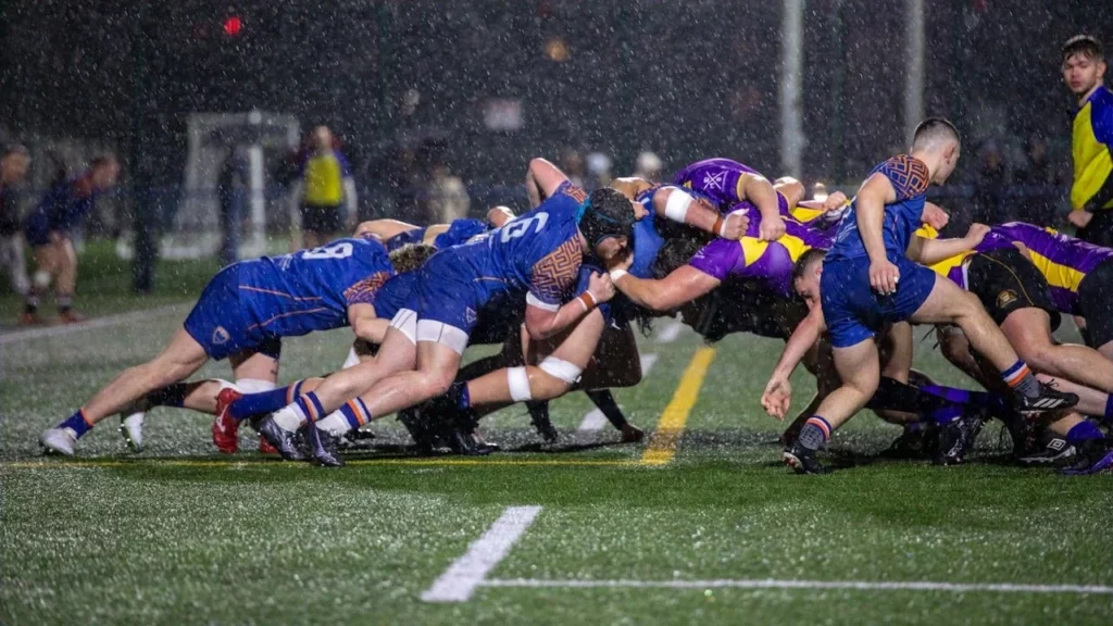 pexels-olliecraig1-20192758 A game of rugby during a scrum in the rain.