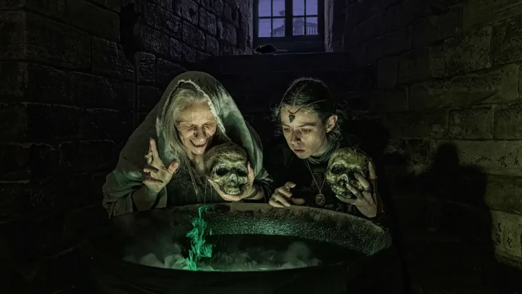 A group of people standing around a bath in a dark room.