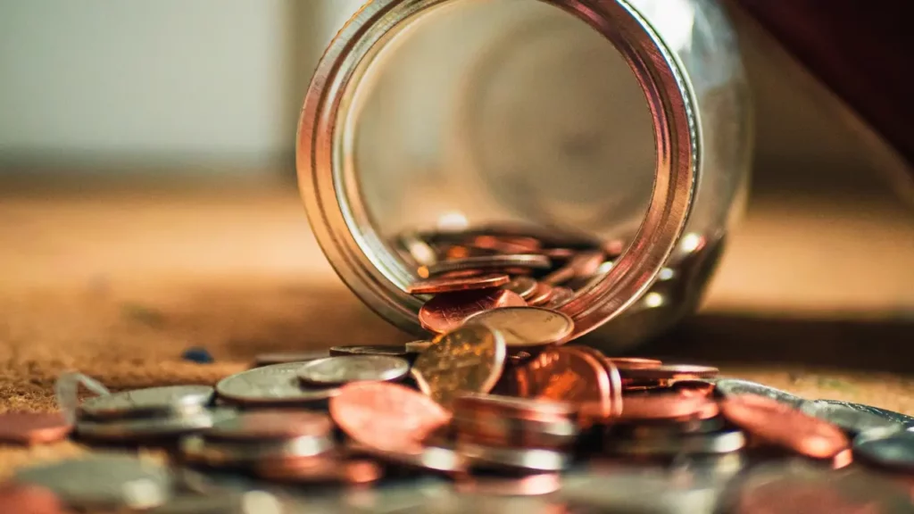 Close-up photo of assorted coins. Themes of economy of fantasy.
