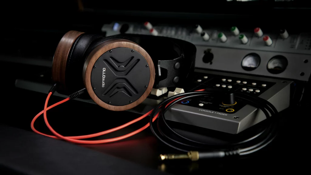 A pair of headphones sitting on top of a table. Themes of modify.