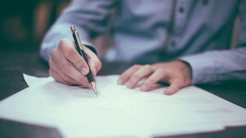 Man writing on paper photo. Themes of separate license.