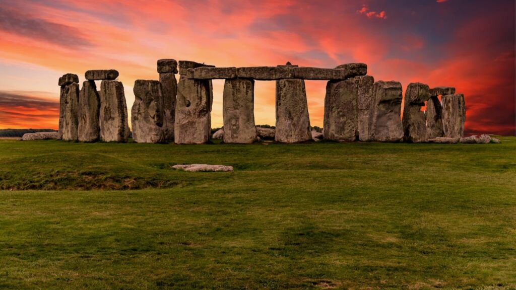 A photo of Stonehenge with a red sky.