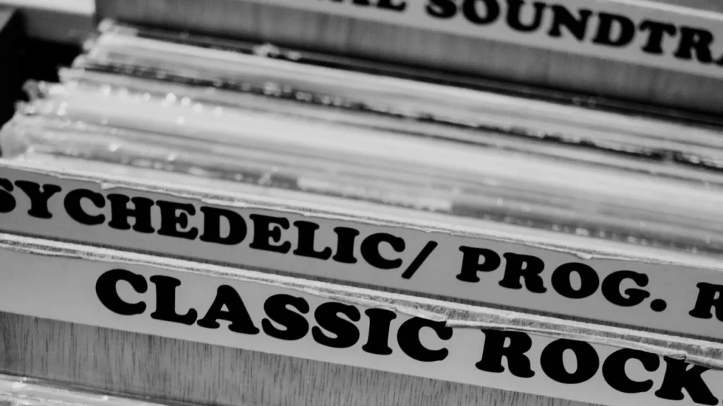 A photo of a box of music LPs separated into different genres in a shop