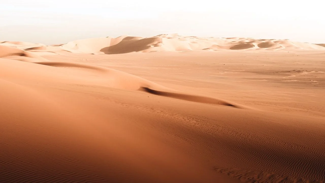 A photo of a sand desert during the day.