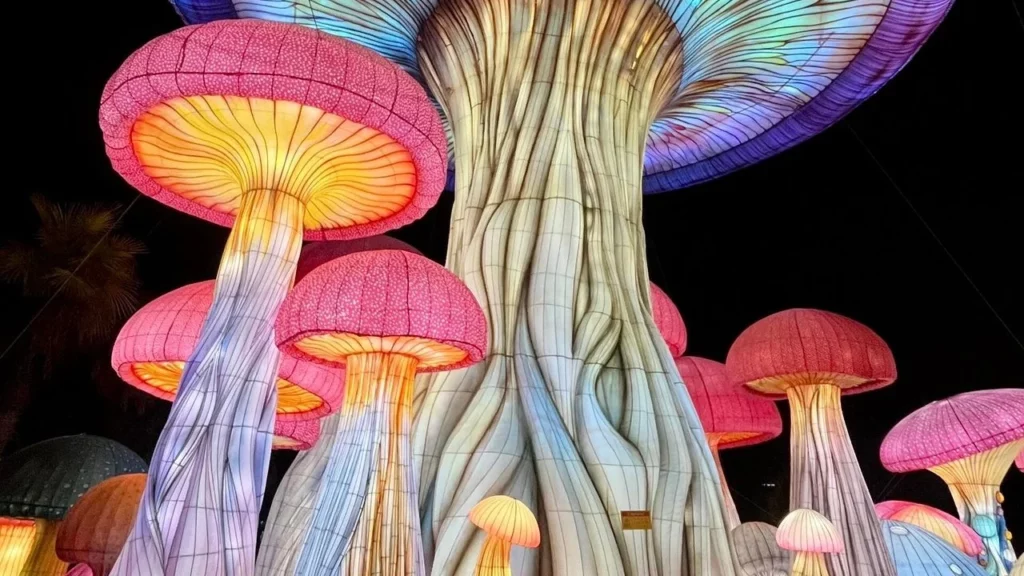 A photo of mushroom sculptures at night.